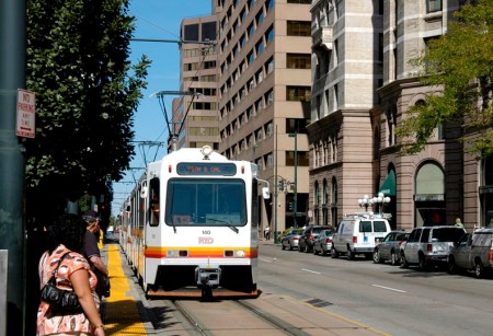 Denver: Passengers waiting to board LRT train running in curbside lane on Stout St. Photo: Peter Ehrlich.